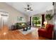 Comfortable living room with a decorative rug, hardwood floors, and large window at 1308 Peachfield Dr, Valrico, FL 33596