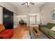 Spacious living room with hardwood floors, ceiling fan, high ceilings, and a rustic sliding barn door at 1308 Peachfield Dr, Valrico, FL 33596