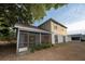 A view of the home's backyard, siding, and screened in porch at 13218 Parkhurst Ct, Riverview, FL 33569