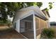 A view of the home's backyard, siding, and screened in porch at 13218 Parkhurst Ct, Riverview, FL 33569