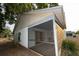 A view of the home's backyard, siding, and screened in porch at 13218 Parkhurst Ct, Riverview, FL 33569