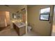 Bathroom features dual sinks, linoleum floors, and a window for natural light at 13218 Parkhurst Ct, Riverview, FL 33569