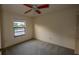 Simple bedroom with a ceiling fan, a window with a view, and a closet at 13218 Parkhurst Ct, Riverview, FL 33569