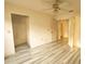 Bedroom with plank flooring, closet, ceiling fan, and neutral paint; perfect for personalization at 13218 Parkhurst Ct, Riverview, FL 33569