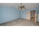 Cozy bedroom features a ceiling fan, carpet flooring, and blue walls at 13218 Parkhurst Ct, Riverview, FL 33569