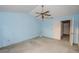 Cozy bedroom features a ceiling fan, carpet flooring, and blue walls at 13218 Parkhurst Ct, Riverview, FL 33569