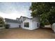 Side view of a two-story home featuring a garage and neutral exterior paint at 13218 Parkhurst Ct, Riverview, FL 33569