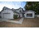 A two-story home with a two-car garage, neutral exterior paint and landscaping at 13218 Parkhurst Ct, Riverview, FL 33569
