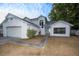 A two-story home with a two-car garage, neutral exterior paint and landscaping at 13218 Parkhurst Ct, Riverview, FL 33569