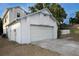 Two-car garage attached to a two-story home with neutral exterior paint at 13218 Parkhurst Ct, Riverview, FL 33569