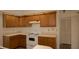 A well-organized kitchen with wooden cabinets and a smooth white countertop at 13218 Parkhurst Ct, Riverview, FL 33569