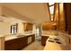 Well-lit kitchen with wood cabinets, double sink and stove at 13218 Parkhurst Ct, Riverview, FL 33569