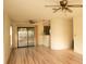 Open living room with ceiling fans and sliding glass doors leading to outdoor area at 13218 Parkhurst Ct, Riverview, FL 33569