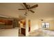 Open-concept living room and kitchen with ceiling fans and ample natural light at 13218 Parkhurst Ct, Riverview, FL 33569