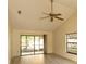 Bright living room with vaulted ceiling, ceiling fan, sliding glass doors to lanai and neutral decor at 13218 Parkhurst Ct, Riverview, FL 33569