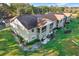 Aerial view of the apartment complex showcasing balconies and surrounding greenery at 1390 Oak Hill Dr # 206, Dunedin, FL 34698