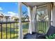 Balcony with railing and a chair, offering a scenic view of the well-manicured lawn at 1390 Oak Hill Dr # 206, Dunedin, FL 34698