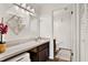 Bathroom features a single sink vanity, open shelving, and a separate toilet area at 1390 Oak Hill Dr # 206, Dunedin, FL 34698