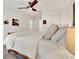 Comfortable bedroom features a ceiling fan, neutral decor, and ample space at 1390 Oak Hill Dr # 206, Dunedin, FL 34698