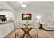 Open dining area with glass table and a view into the bright living room at 1390 Oak Hill Dr # 206, Dunedin, FL 34698