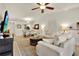 Inviting living room with a ceiling fan, showcasing an open layout with a dining area and plenty of natural light at 1390 Oak Hill Dr # 206, Dunedin, FL 34698