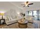 Bright living room featuring modern decor, plush seating, and a sliding door to a balcony at 1390 Oak Hill Dr # 206, Dunedin, FL 34698