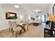Bright, open-concept living area with a glass dining table and modern decor, seamlessly blending with the living room at 1390 Oak Hill Dr # 206, Dunedin, FL 34698