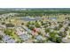 Aerial view of a residential neighborhood with a golf course and lake in the background at 1416 Leland Dr # 49, Sun City Center, FL 33573