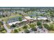 Aerial view showcasing clubhouse, lake, and golf course in residential community at 1416 Leland Dr # 49, Sun City Center, FL 33573