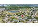 Aerial view showcasing a residential neighborhood with a golf course and lake at 1416 Leland Dr # 49, Sun City Center, FL 33573