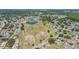 Aerial view of a residential community featuring a walking path and a winding lake at 1416 Leland Dr # 49, Sun City Center, FL 33573