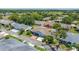 Aerial view of charming home featuring lush landscaping, driveway, and manicured lawns in a golf community at 1416 Leland Dr # 49, Sun City Center, FL 33573