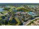 Expansive aerial view of the community center featuring pools, tennis courts, and lush landscaping at 1416 Leland Dr # 49, Sun City Center, FL 33573