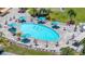 Aerial view of the beautiful community pool, featuring ample seating and umbrellas at 1416 Leland Dr # 49, Sun City Center, FL 33573