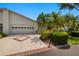 Well-maintained home exterior showcasing a driveway, garage, and lush landscaping for curb appeal at 1416 Leland Dr # 49, Sun City Center, FL 33573