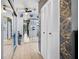 Hallway features wood floors, mirrored closets, and a decorative wall at 1416 Leland Dr # 49, Sun City Center, FL 33573