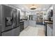 Bright kitchen with stainless steel appliances, white tile floors, and granite countertops at 1416 Leland Dr # 49, Sun City Center, FL 33573