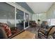 Cozy screened lanai with brick paver floors, string lights and view into sunroom through sliding glass doors at 1416 Leland Dr # 49, Sun City Center, FL 33573