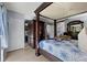 Spacious main bedroom features a four-poster bed and ensuite bathroom at 1416 Leland Dr # 49, Sun City Center, FL 33573