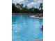 Enjoy a refreshing swim in the sparkling community pool with ample lounge chairs and lush landscaping at 1416 Leland Dr # 49, Sun City Center, FL 33573
