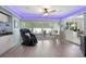 Bright sunroom with floor-to-ceiling windows, modern lighting, dining area, bar and relaxing massage chair at 1416 Leland Dr # 49, Sun City Center, FL 33573