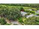 Aerial view of property surrounded by mature trees and lush green landscape at 16804 Windsor Park Dr, Lutz, FL 33549