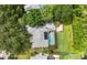 An aerial view of a home showcasing a screened pool area, patio, and a beautifully landscaped backyard at 16804 Windsor Park Dr, Lutz, FL 33549