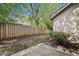 View of the back yard showing a wood fence, sparse landscaping, and part of the home at 16804 Windsor Park Dr, Lutz, FL 33549