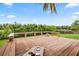 Large wooden deck perfect for entertaining, with a beautiful view of the lush backyard at 16804 Windsor Park Dr, Lutz, FL 33549