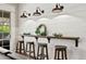 Stylish bar area with a wooden countertop, stools, and decorative lighting at 16804 Windsor Park Dr, Lutz, FL 33549