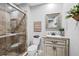 Tiled bathroom with frameless shower, marble countertop, and decorative mirror at 16804 Windsor Park Dr, Lutz, FL 33549