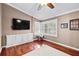 Comfortable bedroom with a window and wood flooring, providing natural light and warmth at 16804 Windsor Park Dr, Lutz, FL 33549