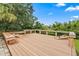 Spacious deck with wood benches overlooking the greenery offers a relaxing outdoor area at 16804 Windsor Park Dr, Lutz, FL 33549