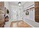 Inviting entryway with decorative doors, coat rack, and tile flooring at 16804 Windsor Park Dr, Lutz, FL 33549